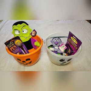 Two Halloween buckets with plush toys, pendant, pen, & other toys.